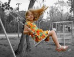 Little girl on a swing